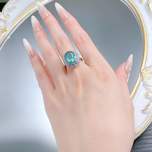 Macro detail of S925 silver ring with large oval green gemstone and diamond pavé