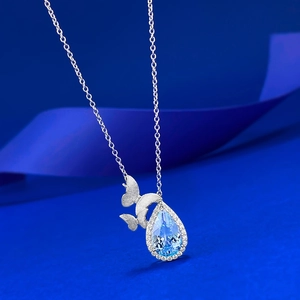 Elegant S925 silver topaz necklace with blue pear-shaped pendant and twin butterflies