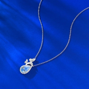 Detail macro view of blue teardrop topaz pendant with sparkling micro-pave crystals