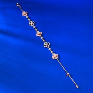 Macro detail of rose gold S925 silver bracelet featuring pink clover and pave zircon charms