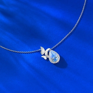 Elegant S925 silver butterfly necklace with light blue teardrop topaz pendant and pavé diamonds