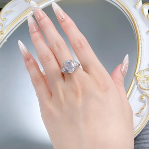 Macro detail of S925 silver oval cut high carbon diamond bow ring on model's hand