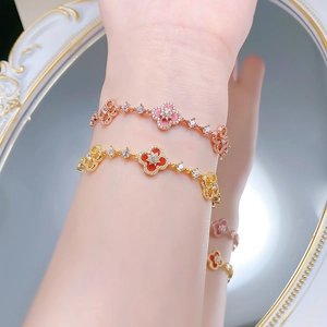 Detailed shot of S925 silver clover bracelets with pink and red enamel on wrist