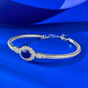 Elegant S925 silver bracelet featuring a 6x8mm royal blue oval gemstone with milgrain detailing
