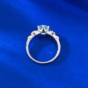 Close-up of aquamarine ring with crown six-prong setting and carved hollow details