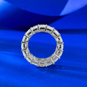 Detailed macro shot of an eternity band with emerald cut sparkling gemstones
