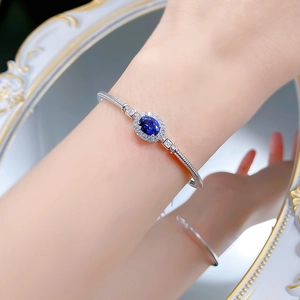 Detailed close-up of a silver royal blue sapphire bangle featuring a vintage cluster setting