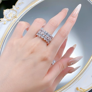 Macro shot of two stacked S925 silver rings with emerald cut cubic zirconia on hand
