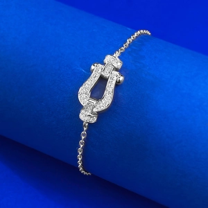 Elegant S925 sterling silver horseshoe bracelet with sparkling pave-set zircons on blue base