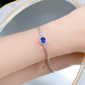 Close-up of S925 silver bracelet featuring an oval blue sapphire and pavé diamonds