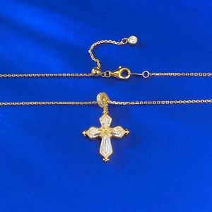 Golden S925 silver iris cross necklace with baguette-cut stones on blue silk