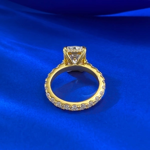 Macro detail of a 9x12mm rectangular radiant-cut diamond ring on blue silk fabric
