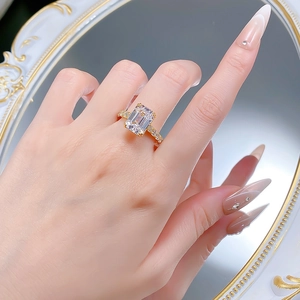Close-up of S925 silver emerald-cut white carbon diamond ring on a model hand