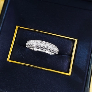 Macro detail of S925 silver band ring with pavé sparkling stones in blue velvet box