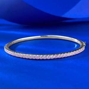 S925 sterling silver bangle featuring a half-pavé row of sparkling pink round cubic zirconia