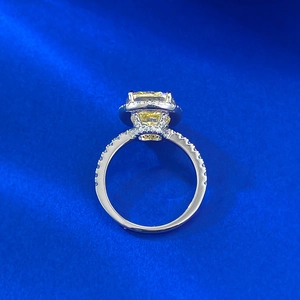 Detail of cushion cut yellow diamond ring with micro-pave setting on S925 silver band