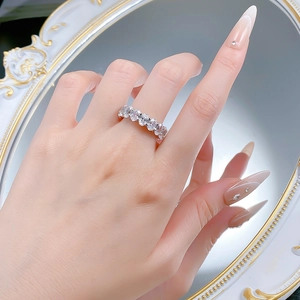 Elegant S925 silver ring featuring a row of oval cut diamonds worn on a finger