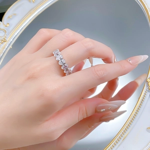 Close-up of S925 silver oval cut solitaire ring worn on finger with sparkling cubic zirconia