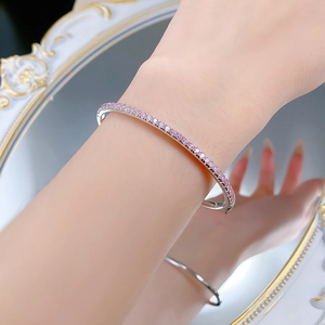 Close-up of S925 sterling silver bangle with pink zircon stones worn on wrist