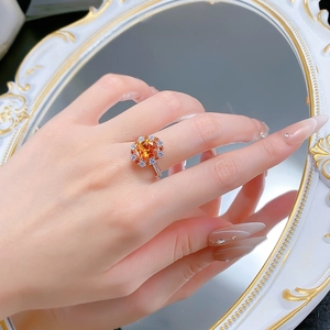 Vue macro d'une bague en argent 925 avec diamant orange ovale de 4 carats et halo de cristaux