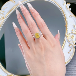 Detail of a square yellow high carbon diamond ring in S925 silver with a halo setting