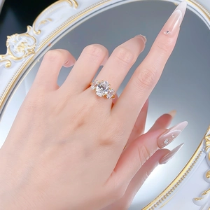 Three-stone S925 silver ring featuring an oval-cut center diamond on a woman's hand