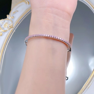Close-up of S925 silver bracelet with pink crystals on wrist with mirror background