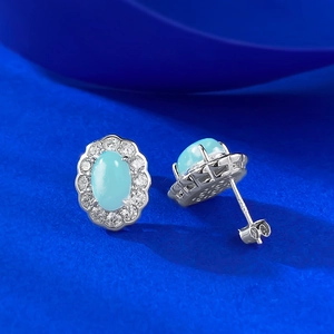 Detailed macro view of S925 silver Larimar stud earrings with blue zircon halo and hallmark