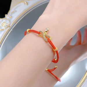 Adjustable red braided rope bracelet with gold plated snake charm and sparkling crystals