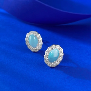 S925 silver oval blue larimar stud earrings with white zircon halo on artistic blue background