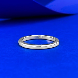 Classic minimalist 925 sterling silver plain ring band with polished finish on blue surface