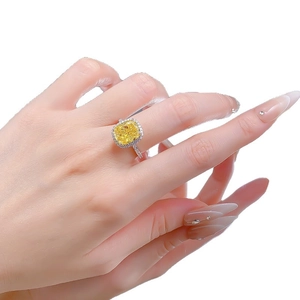 Luxurious S925 silver halo ring featuring a square yellow high carbon diamond on a finger