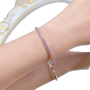 Minimalist S925 sterling silver open bangle featuring pink cubic zirconia stones on wrist