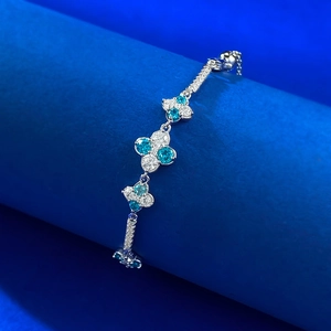 Elegant S925 silver four-leaf clover bracelet featuring blue and white round crystals