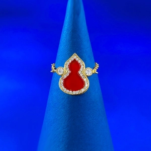 Macro shot of 925 silver gold-plated ring with red agate gourd and diamond inlay