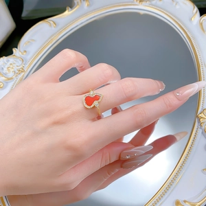 Detail of red agate gourd ring in 925 silver with sparkling crystals on a woman hand