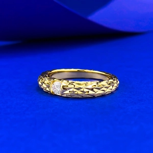 Detailed view of gold-plated dragon scale ring with brilliant center moissanite stone