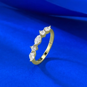 Macro view of gold 925 silver ring featuring marquise and round cut stones in claw setting