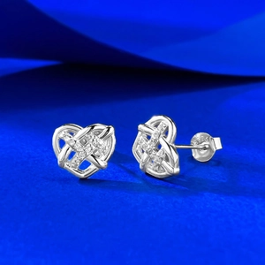 Macro shot of S925 sterling silver heart stud earrings with hollow woven design