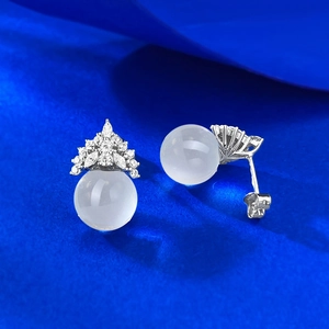 Close-up of S925 silver snowflake crown stud earrings with white crystal beads