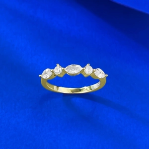 Detail of S925 silver ring featuring marquise, round, and pear cut crystals on a gold band