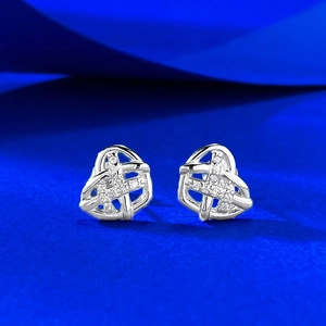 Macro shot of S925 silver heart stud earrings with woven frame and cubic zirconia