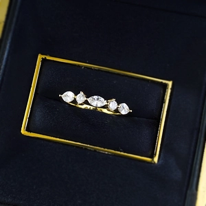Macro shot of gold marquise cut five-stone ring displayed in a black velvet jewelry box