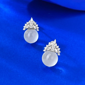 S925 silver crown stud earrings with round white crystal stones on blue background