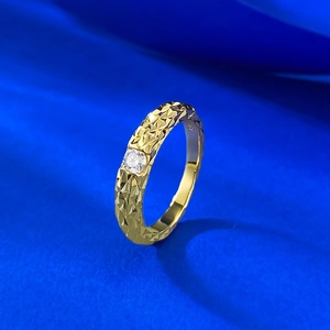Macro view of gold S925 silver ring featuring geometric facets and a central round stone