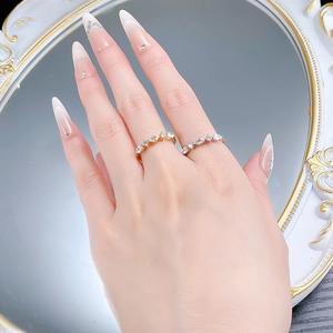 Detail of 925 silver marquise-cut stacked rings in gold and silver finish on hand