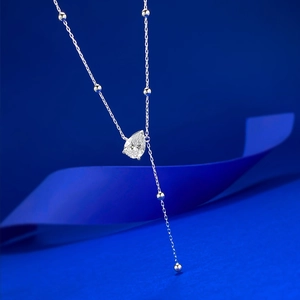 Macro view of pear-shaped teardrop pendant on an S925 silver beaded Y-necklace