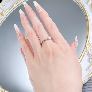 Detail shot of marquise and round cut zircon stones on a sterling silver band worn by model