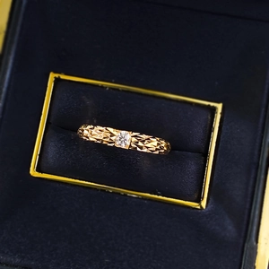 Macro shot of 925 silver moissanite ring with textured dragon scale pattern in a gift box