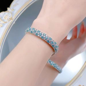 Detailed close-up of a three-row S925 silver bracelet with sparkling diamonds and teal stones